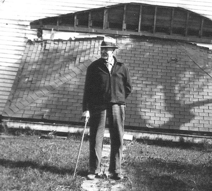 Text Box: 87. Sam Grant Huffman
      surveying the tornado
      damage to his home in
      Riddle Hill, Illinois in
      1942.
